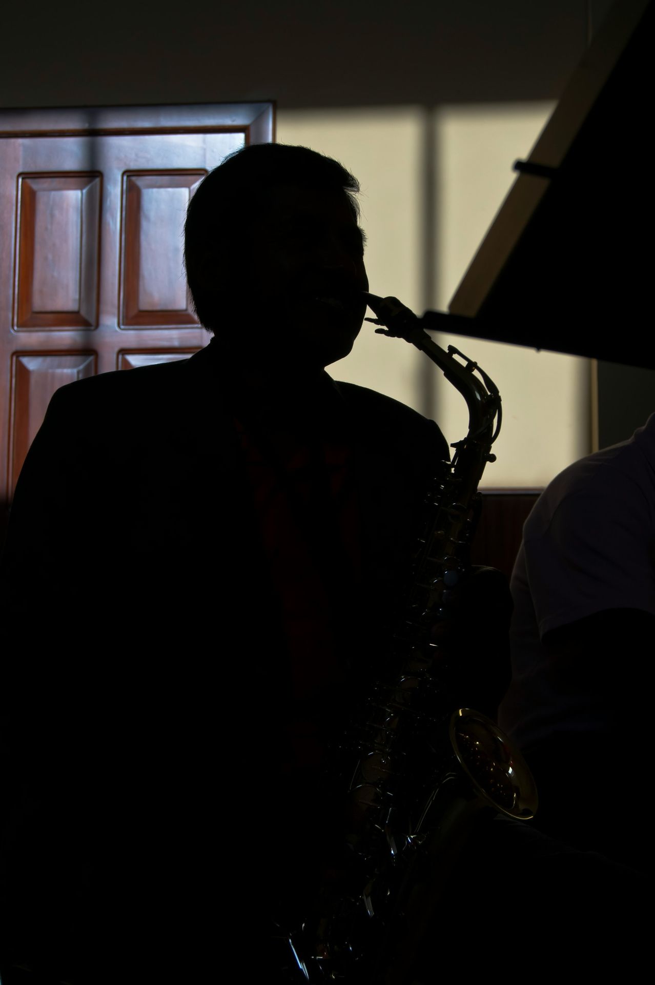 Silhouette of a man playing the saxophone